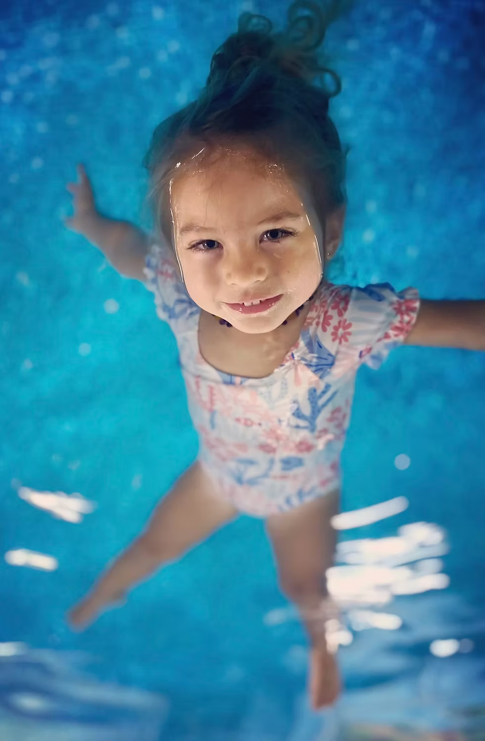 Child learning survival swim lessons